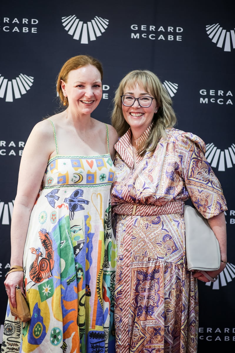 (Left to right): Attendees Rowan and Emma taking a photo in front of our media wall.